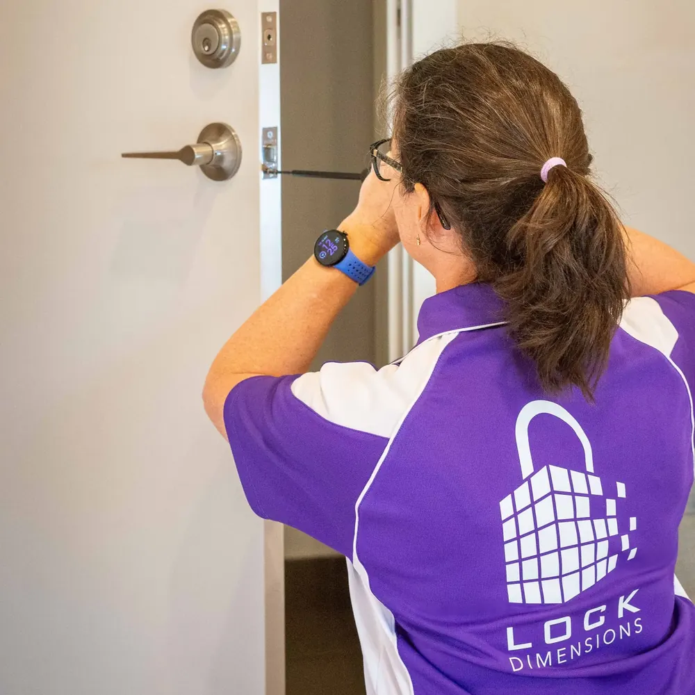 Lyndal fitting a lock on a front door